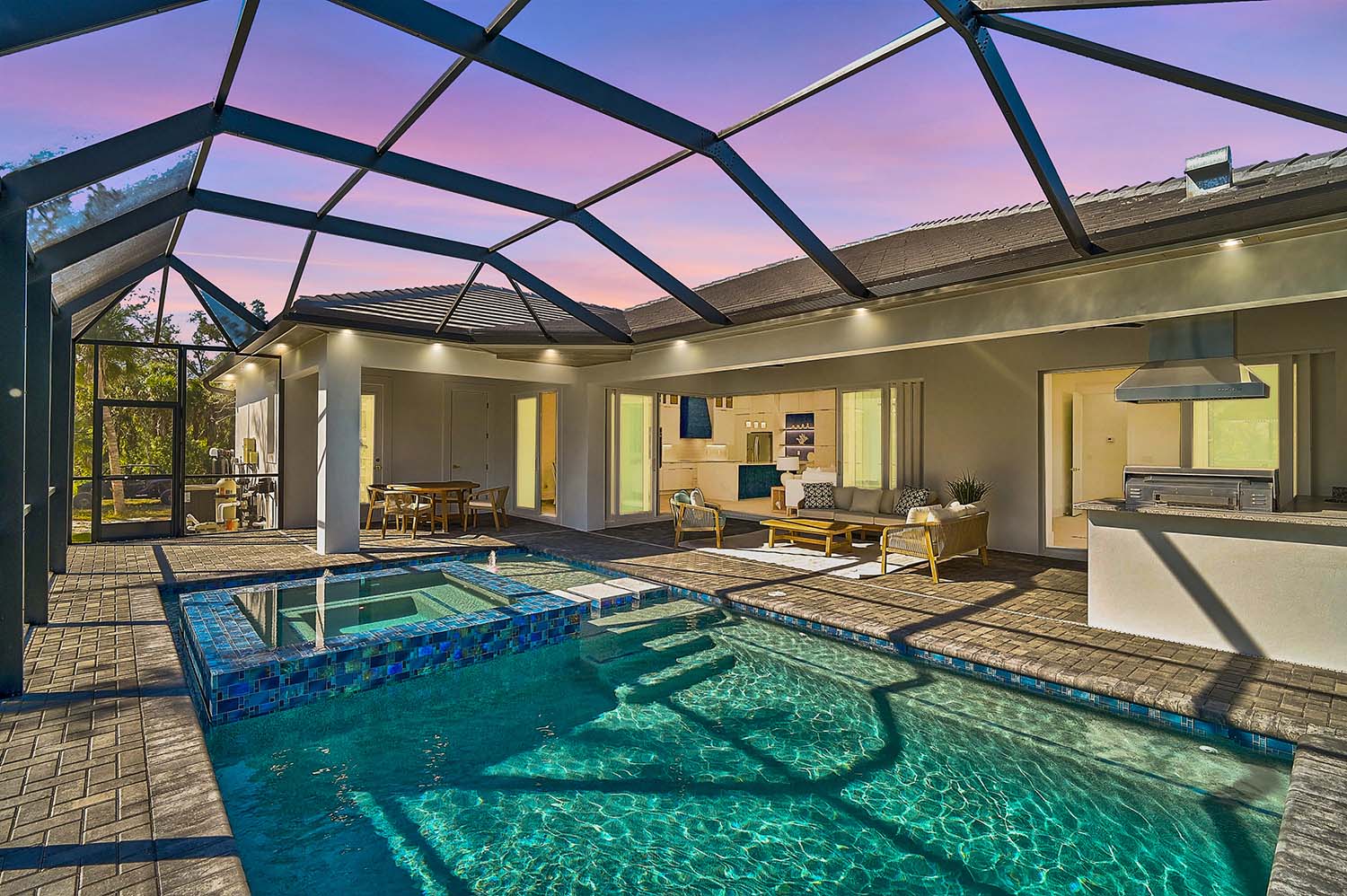 Luxurious outdoor living space with pool and screened enclosure